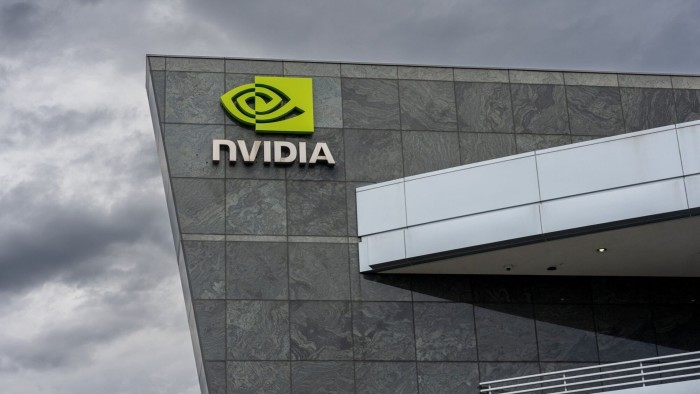 Nvidia logo on the exterior of the company’s headquarters building, with a cloudy sky in the background.