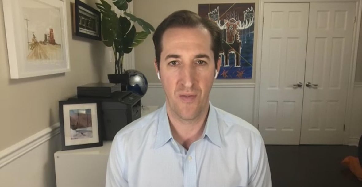 Screenshot from a Zoom call showing a man with short brown hair talking in a blue shirt.