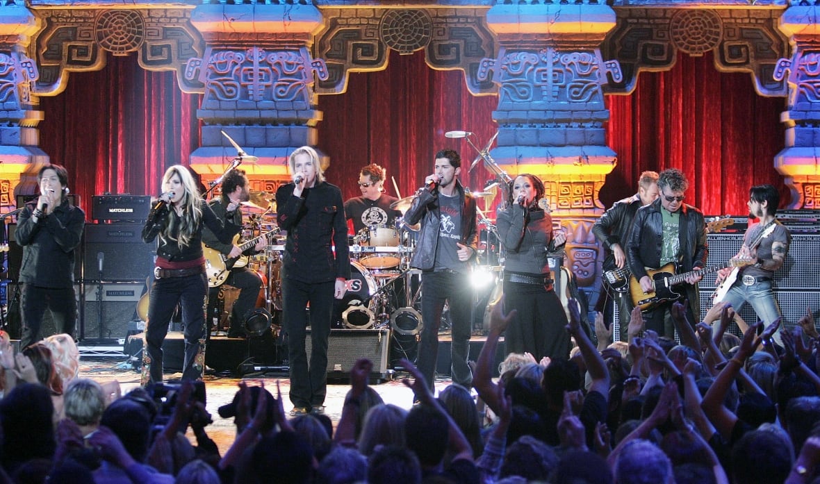 Singing contestants are shown on stage performing in a reality television show.