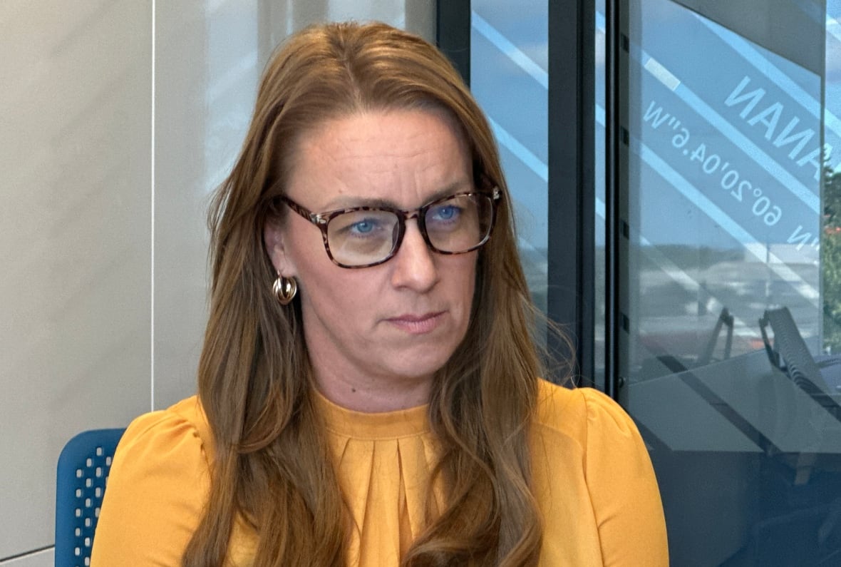 A woman sits in a chair. 