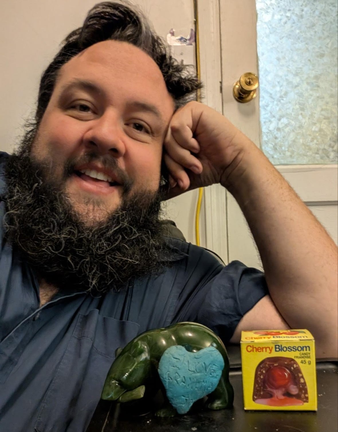A man poses with a yellow box that says cherry blosson