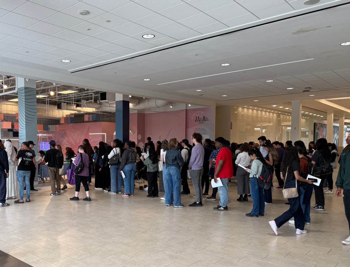 Linup of people holding paper.