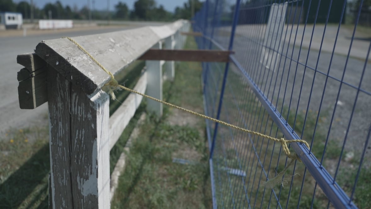 Metal mesh fencing erected parallel to the wooden fencing with ropes tied between the two fences