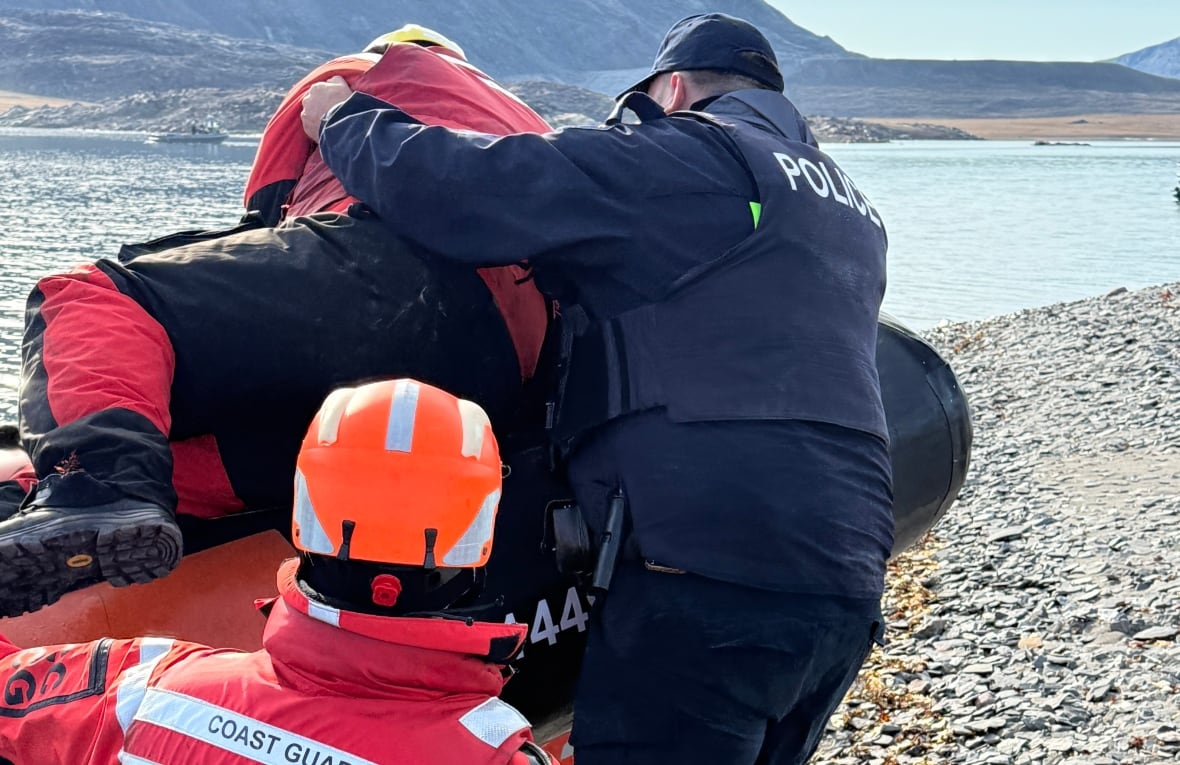 Two uniformed men, both with their backs to the camera, grapple with a third man.