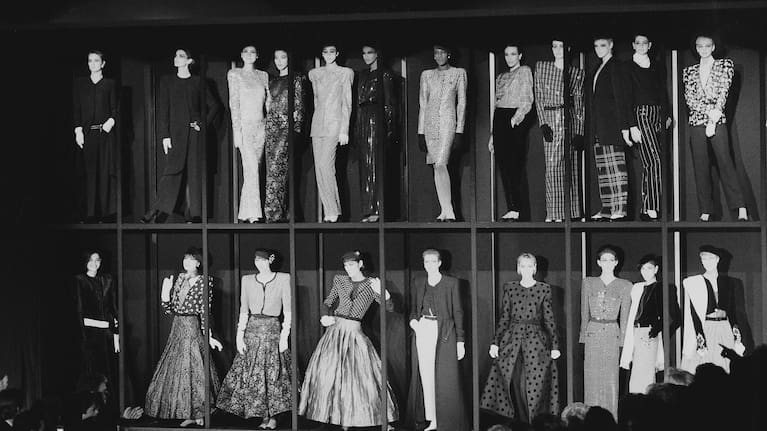 Models presenting the Giorgio Armani fashion collection stand in showcases at the end of the showing for Fall-Winter 1985-86 in Milan, March 13, 1985.