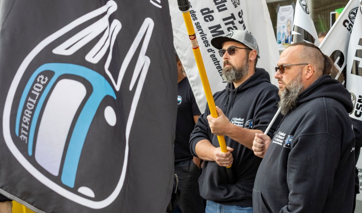 Syndicat du transport de Montreal workers hold signs outside the STM Frontenac Transportation Centre in Montreal 