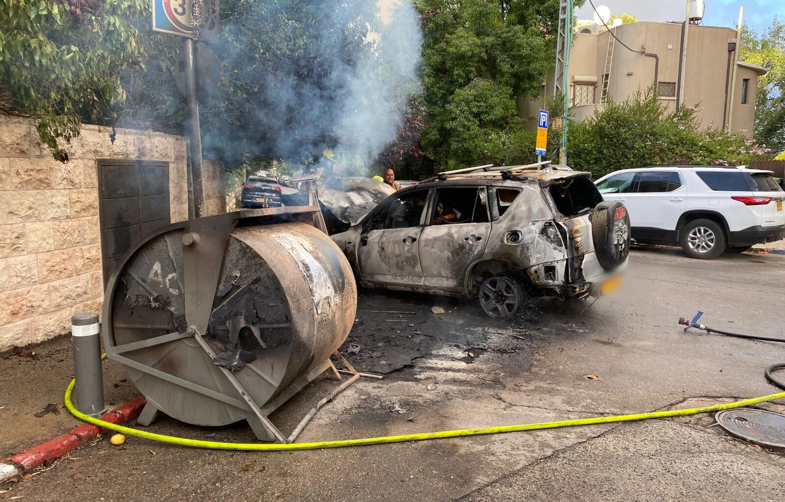 Car burns near PM's residence as protesters torch dumpsters, drawing politicians' ire
