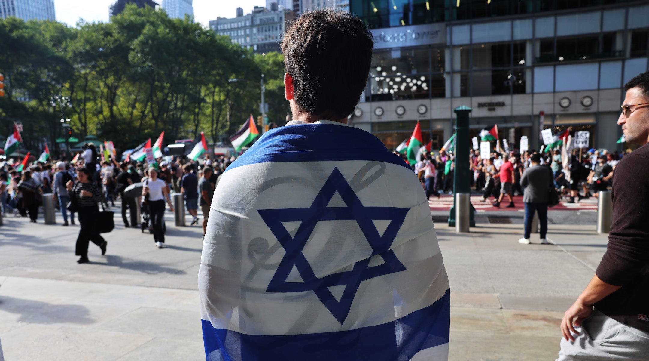 A man holds an Israeli flag as Pro-Palestinian protesters march through Manhattan near the United Nations as Israeli Prime Minister Benjamin Netanyahu addresses the United Nations General Assembly on Sept. 26. (Spencer Platt/Getty Images)