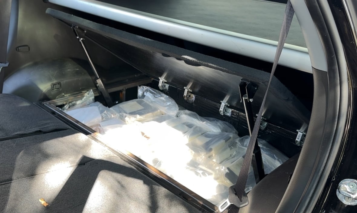 Bags of white powder inside a hidden compartment in a vehicle 