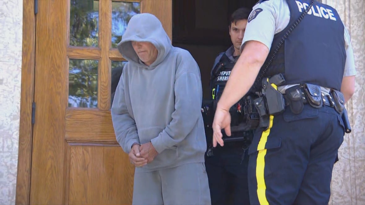 Man in grey sweatsuit walks out of courthouse in handcuffs