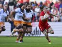 Canada's Karen Paquin, right, breaks away to score a try during the Women's Rugby World Cup 2025 quarterfinal match between Canada and Australia, in Bristol, England, Saturday, Sept. 13, 2025.