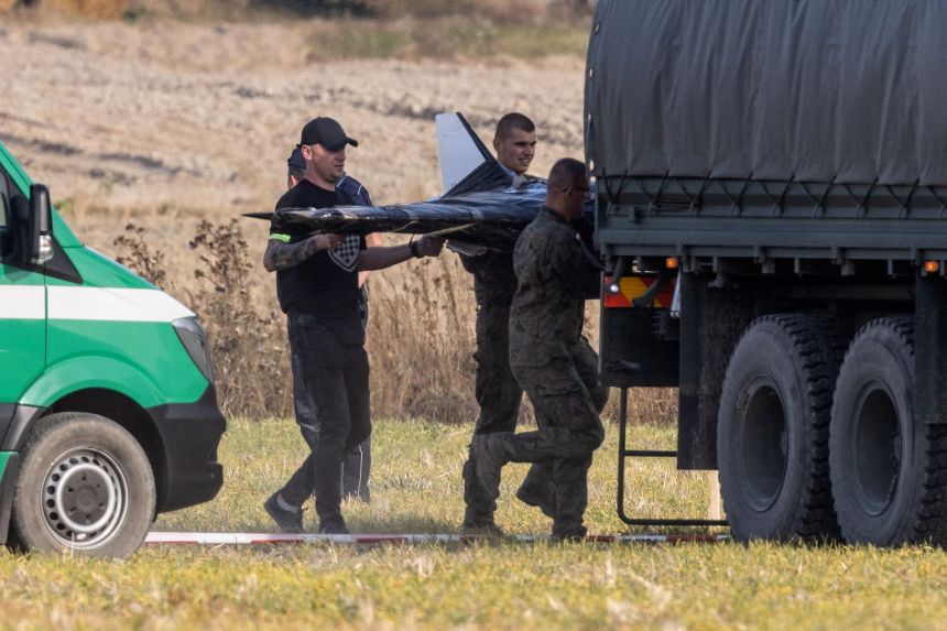 Polish forces at the crash site of a Russian drone in the village of Wohyn, eastern Poland, on Wednesday.