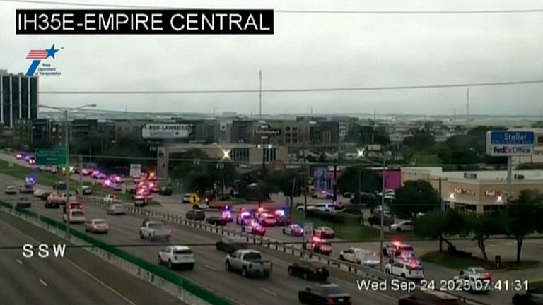 Police cars and ambulances stand outside a ICE facility where a shooting took place in Dallas. Pic: AP