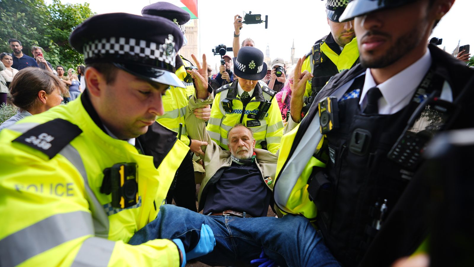 A protester is carried away by police in Parliament Square. Pic: PA