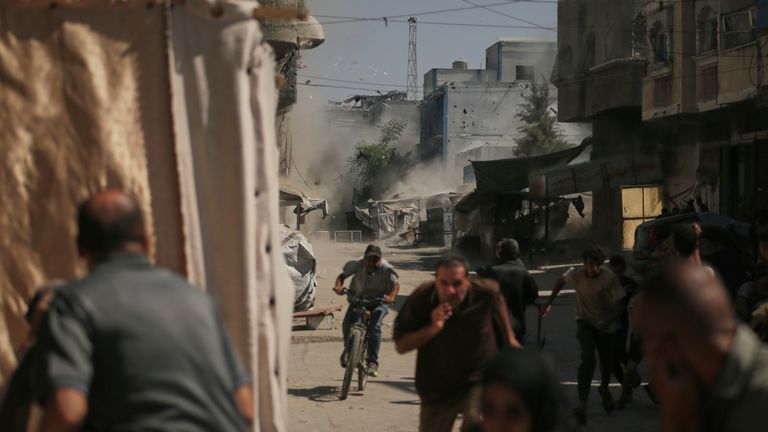 Palestinians run for cover. Pic: AP