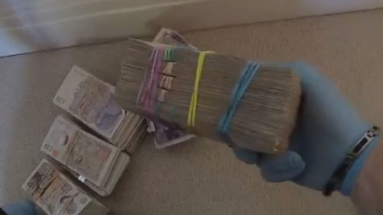 Bundles of cash found in a police search. Pic: CPS