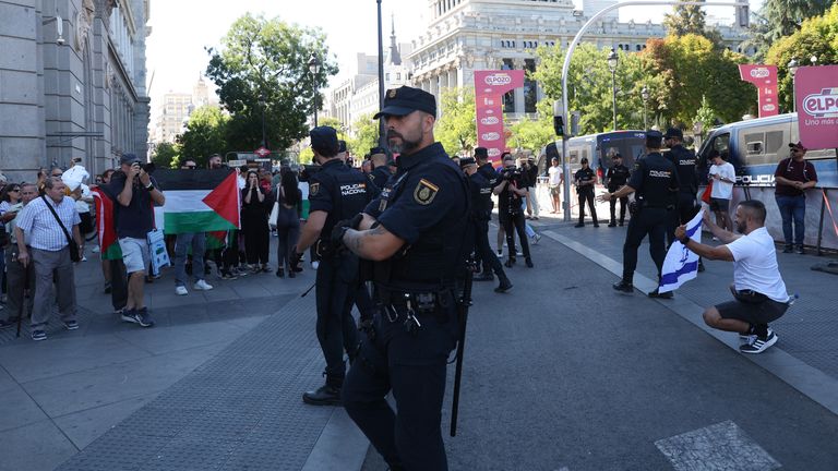 Police officers stand between pro-Palestinian and pro-Israel demonstrators on Sunday afternoon. Pic: Reuters