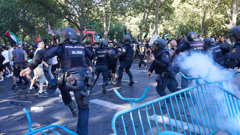 Police charge several people protesting. Pic: AP