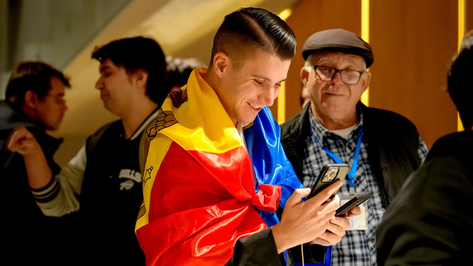 A supporter of the pro-EU Party of Action and Solidarity smiles as he checks partial results. Pic: AP