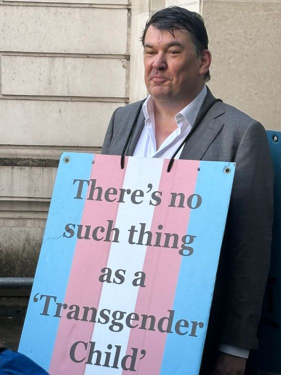 He posed with a sign outside court with the message: 'There's no such thing as a 'transgender child'