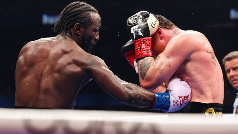 Terence Crawford (left) throws a right-hand punch at opponent Saul 'Canelo' Alvarez (right) in Las Vegas fight on September 14, 2025