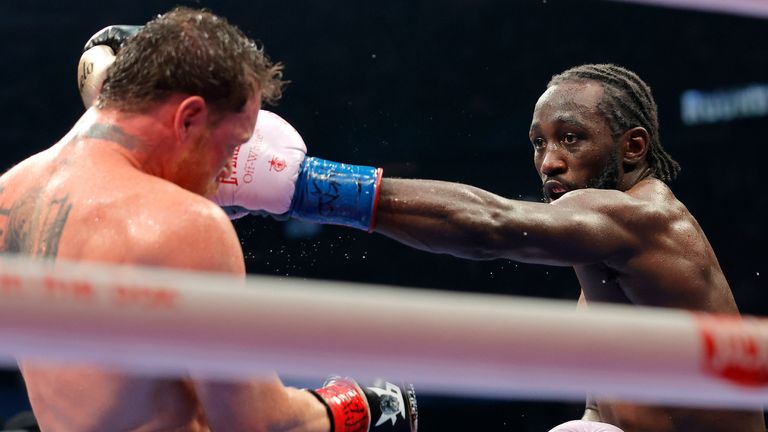 Terence Crawford (right) throws a left-hand punch at opponent Saul 'Canelo' Alvarez in Las Vegas fight on September 14, 2025