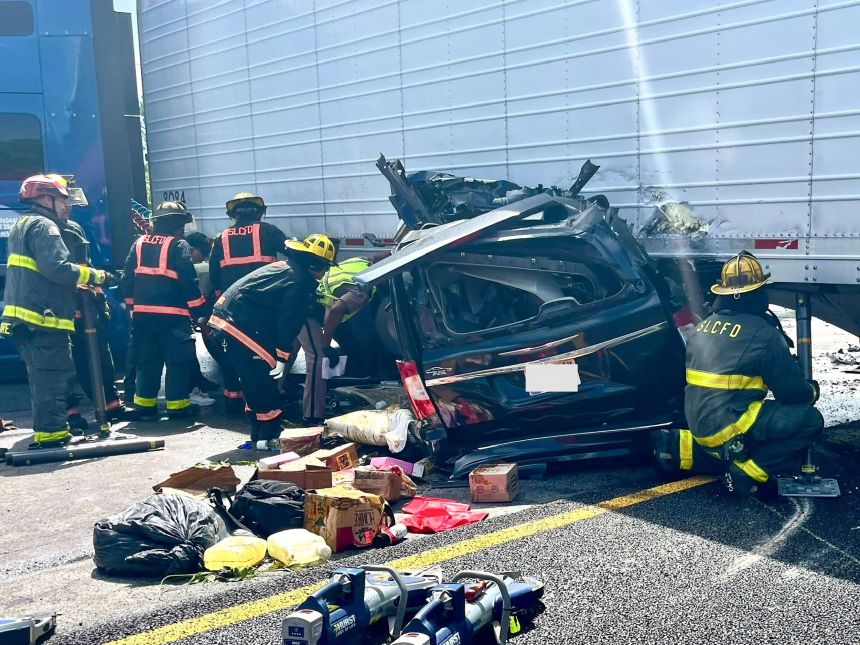 St. Lucie County Sheriff's Deputies work to investigate the wreck of a minivan and semi truck on the Florida Turnpike in Fort Pierce, Florida. August 12, 2025. A portion of this image has been obscured by the source.