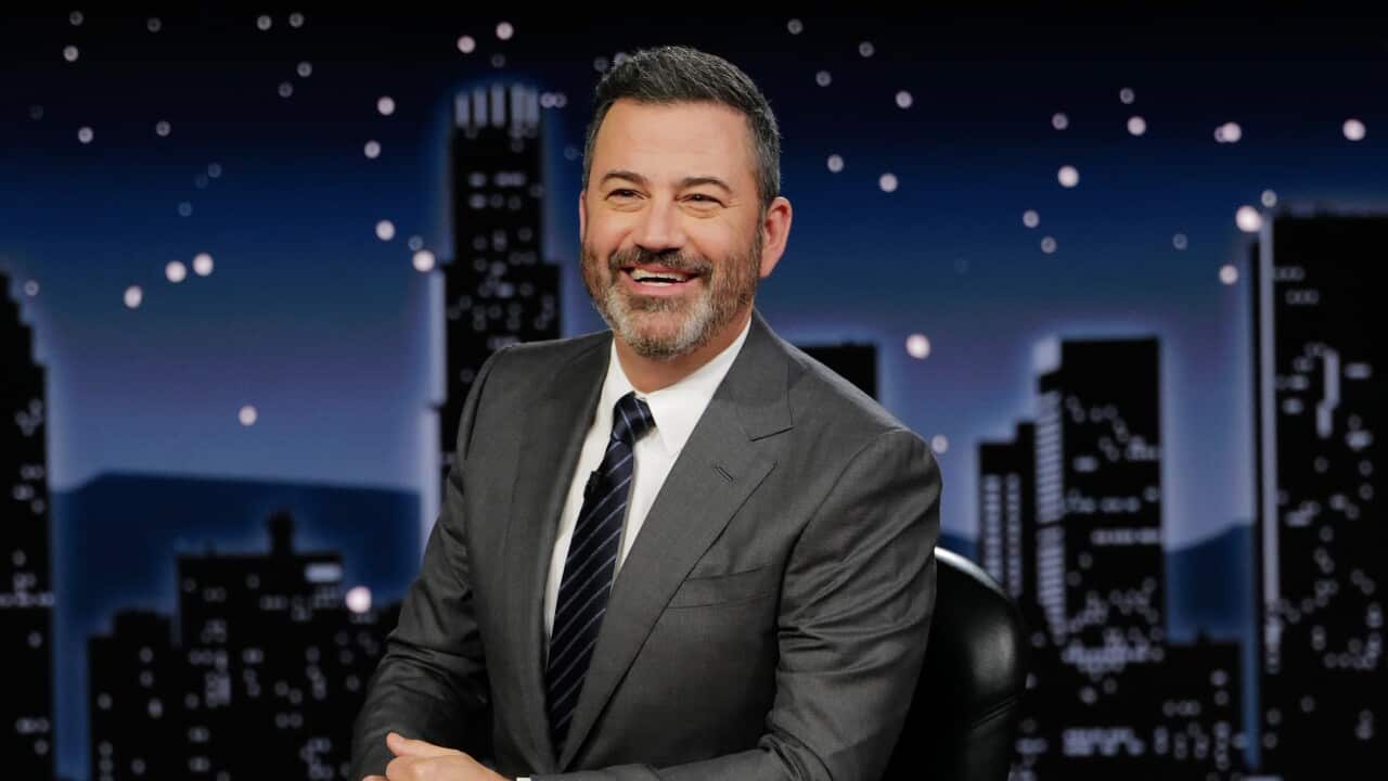 Jimmy Kimmel seated at a desk.