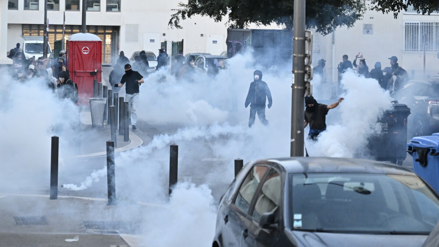 Protesters block roads and set blazes in France amid police tear gas