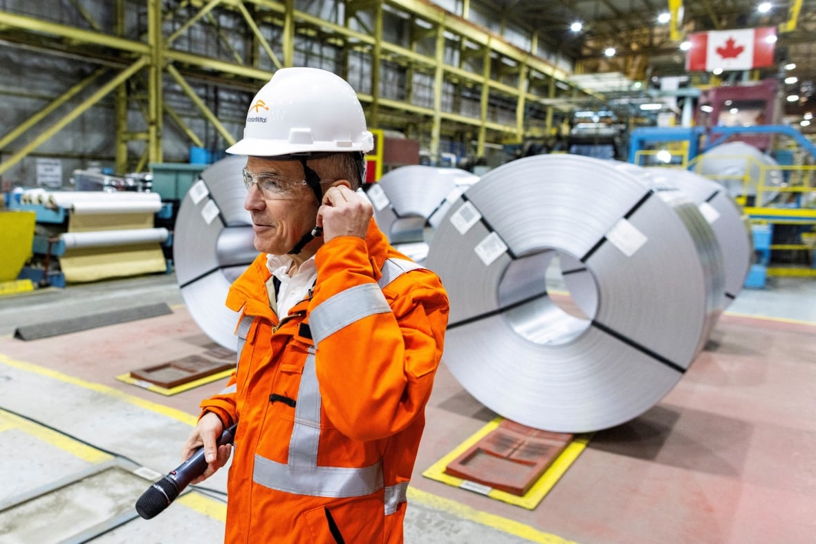 Prime minister-designate Mark Carney prepares to speak to workers while he visits the ArcelorMittal Dofasco steel mill in Hamilton, Ont., March 12, 2025.
