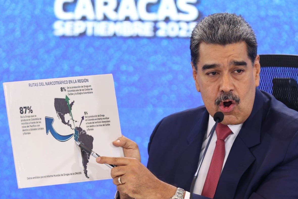 Venezuelan President Nicolás Maduro pointing at map of the Americas.