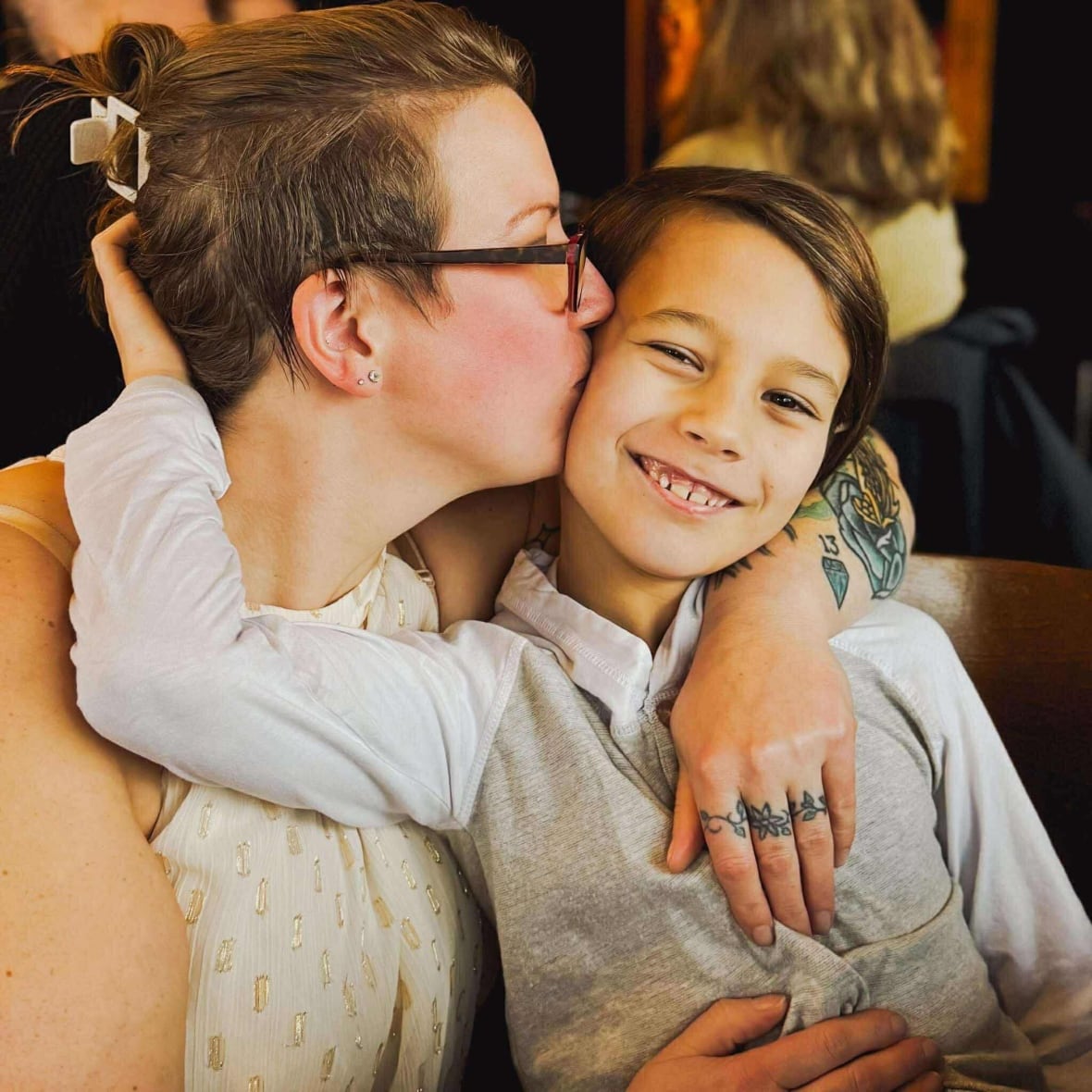 A mother and smiling child embrace