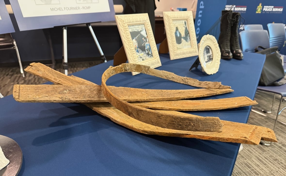 Some strips of very old looking wood sit on a table.