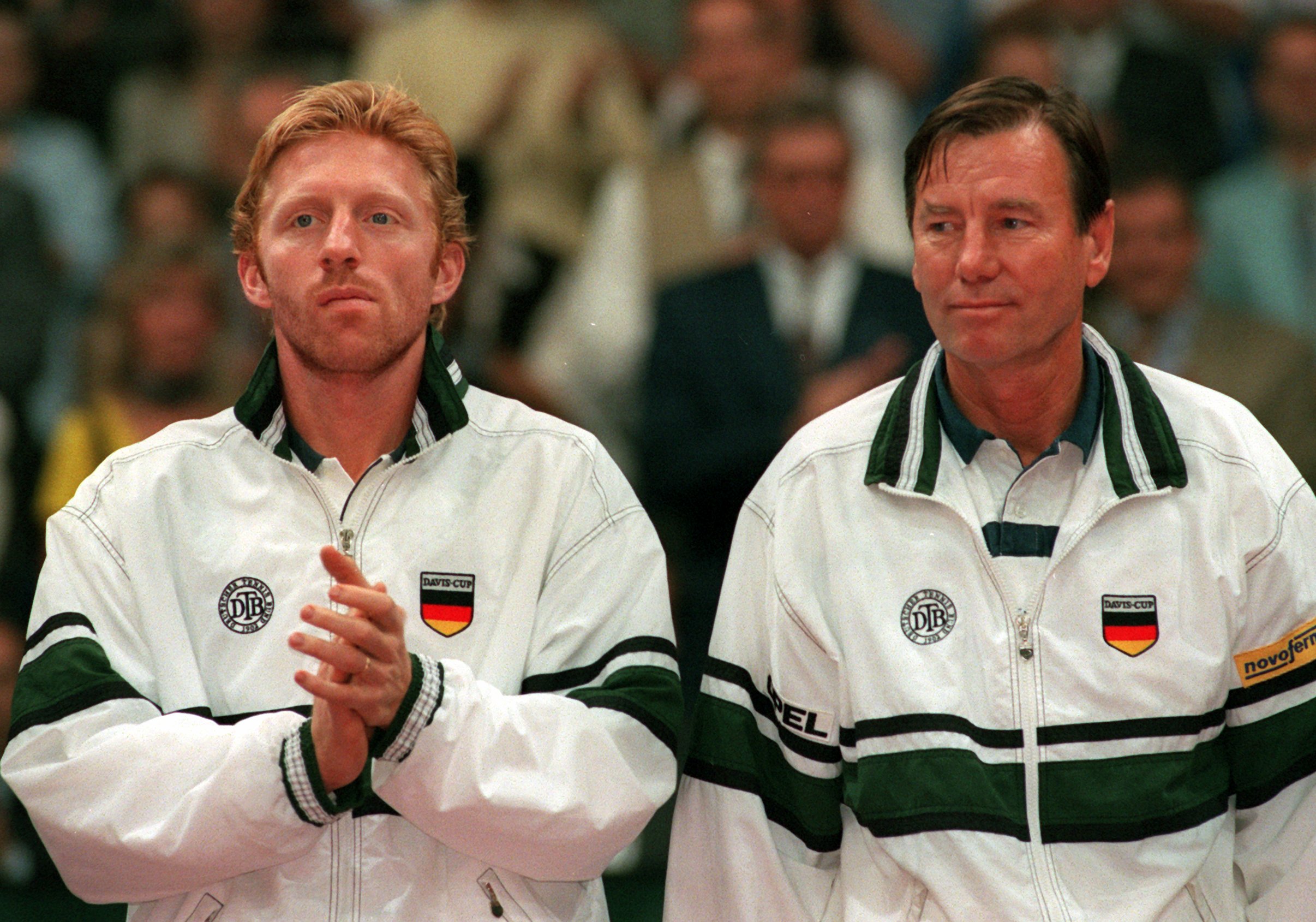 Tennis player Boris Becker and team captain Niki Pilic in Davis Cup apparel.