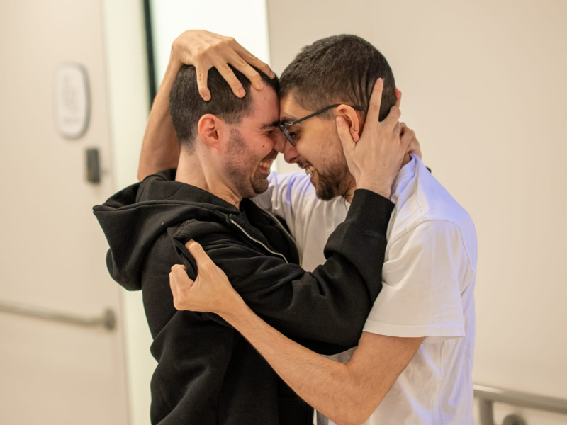 Evyatar David and Guy Gilboa-Dalal hugging and smiling.