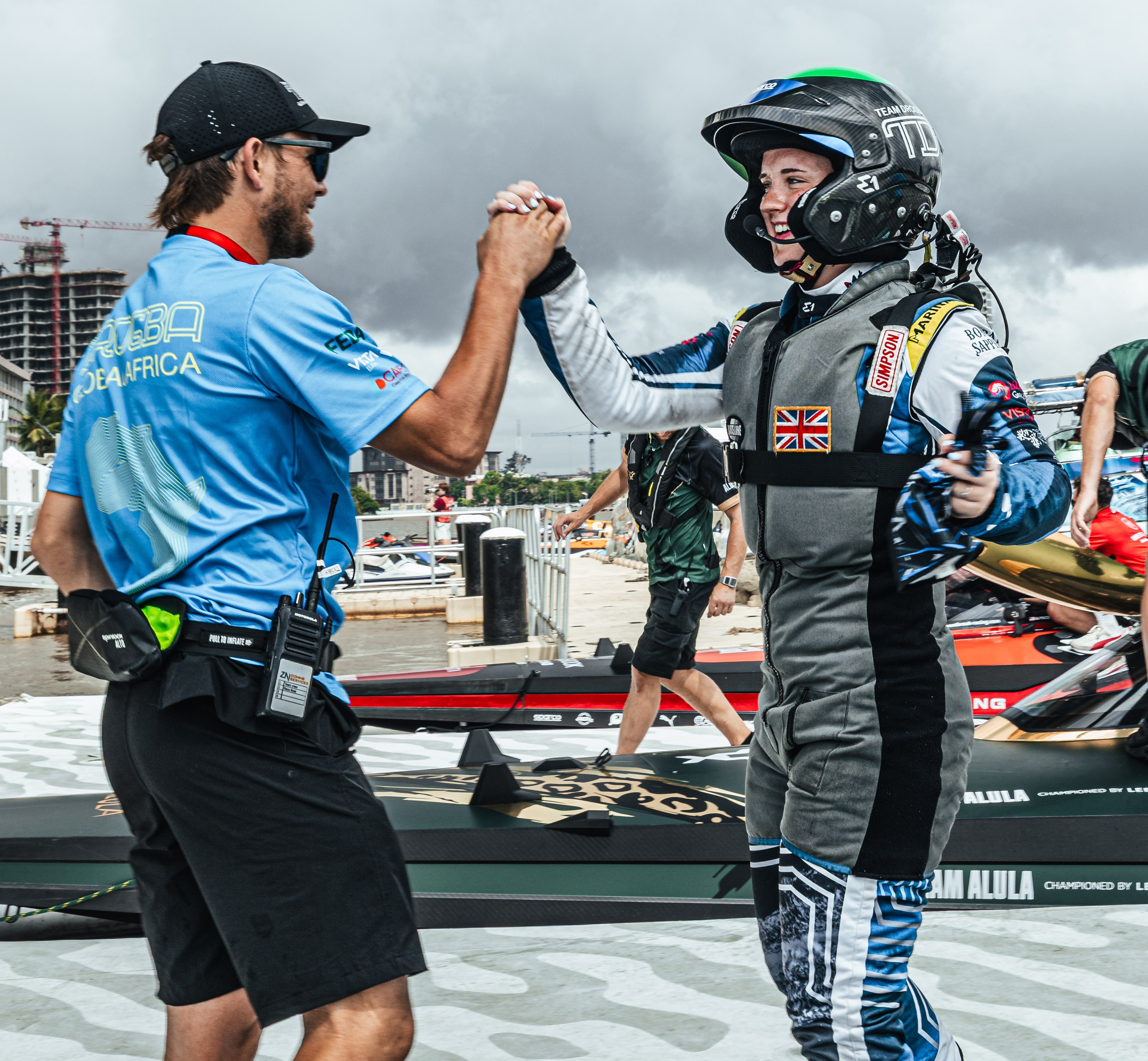 Oban Duncan and a man shaking hands on a boat at E1 Lagos GP.