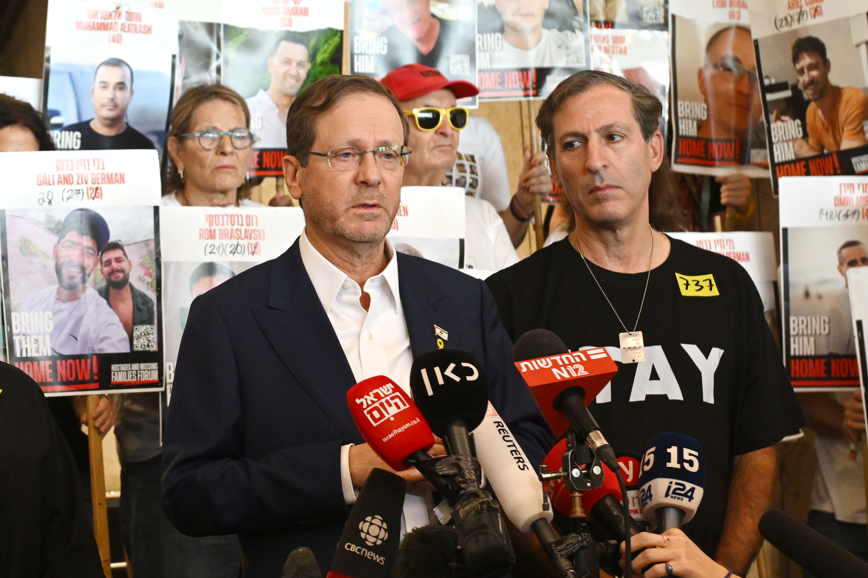 President of Israel, Isaac Herzog, with Ruby Chen, and the families of hostages, speaking to the media at hostage square in Tel Aviv.