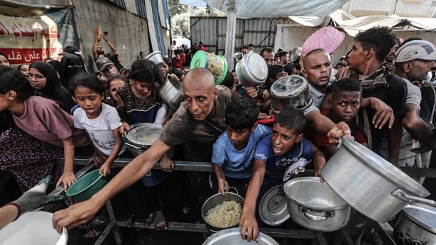 GAZA CITY, GAZA - SEPTEMBER 28: Palestinians facing difficulties accessing food are provided with hot meals by a charity organization due to Israel's blockade of the Gaza Strip and ongoing attacks at the Nuseirat Refugee Camp in central Gaza on September 28, 2025. (Photo by Moiz Salhi/Anadolu via Ge