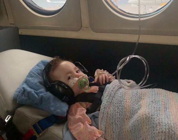 Eva Chalmers on a plane home to Glasgow after heart surgery at CHI Crumlin
