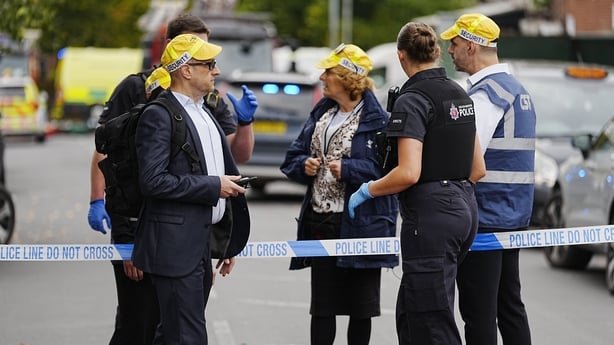 Members of the Community Security Trust (CST) speak to a police officer at the cordon near the scene of an incident at Heaton Park Hebrew Congregation synagogue in Crumpsall, Manchester