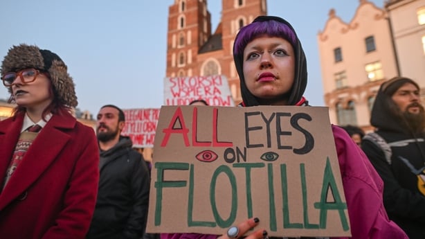 Woman stands with a pro-Palestine sign in Krakow