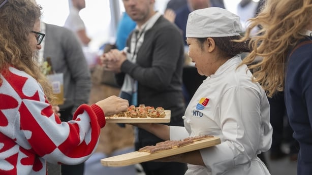 person handing out food samples