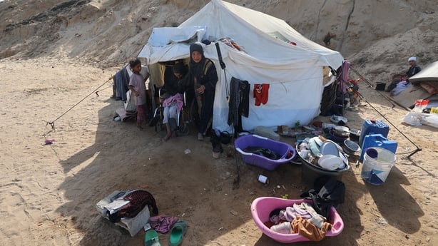 People shelter in a tent in Gaza