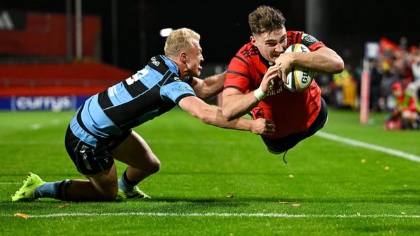 4 October 2025; Ruadhan Quinn of Munster scores his side's first try despite the efforts of Johan Mulder of Cardiff Rugby during the United Rugby Championship match between Munster and Cardiff Rugby at Thomond Park in Limerick. Photo by Brendan Moran/Sportsfile
