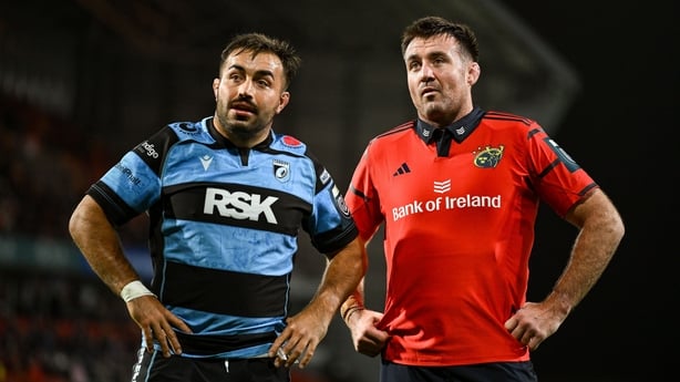 4 October 2025; Munster captain Niall Scannell, right, and Cardiff captain Liam Belcher converse as referee Adam Jones, not pictured, makes a TMO decision during the United Rugby Championship match between Munster and Cardiff Rugby at Thomond Park in Limerick. Photo by Brendan Moran/Sportsfile