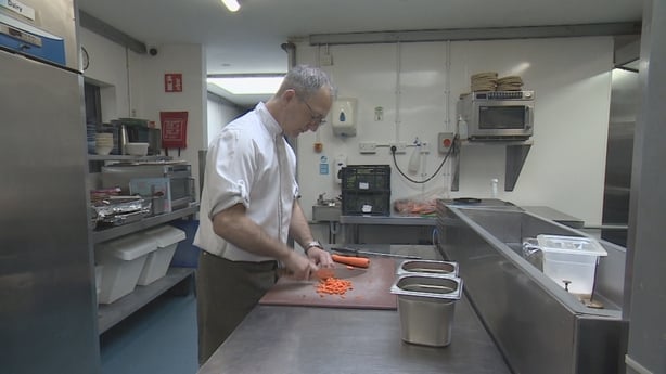 Gary Anderson chopping carrots in his restaurant's kitchen