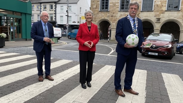 Catherine Connolly with two people posing for a photo