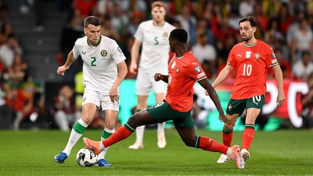 Seamus Coleman of Republic of Ireland in action against Nuno Mendes of Portugal during the FIFA World Cup 2026 Group F qualifying match between Portugal and Republic of Ireland at Estádio José Alvalade in Lisbon, Portugal.