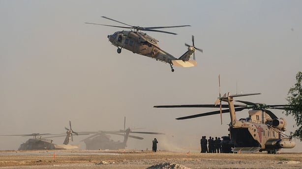 Israeli military helicopters wait in preparation to take hostages released by Hamas in Gaza to hospitals in Israel