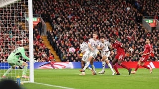 LIVERPOOL, ENGLAND - OCTOBER 19: Harry Maguire of Manchester United scores his team's second goal past Giorgi Mamardashvili of Liverpool during the Premier League match between Liverpool and Manchester United at Anfield on October 19, 2025 in Liverpool, E